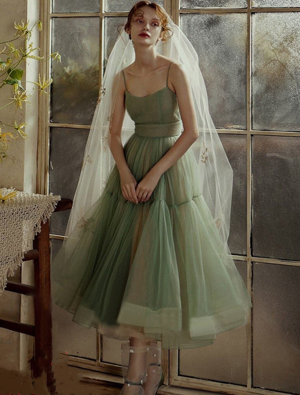 A-line tea length prom dress with spaghetti straps and pleated tulle.