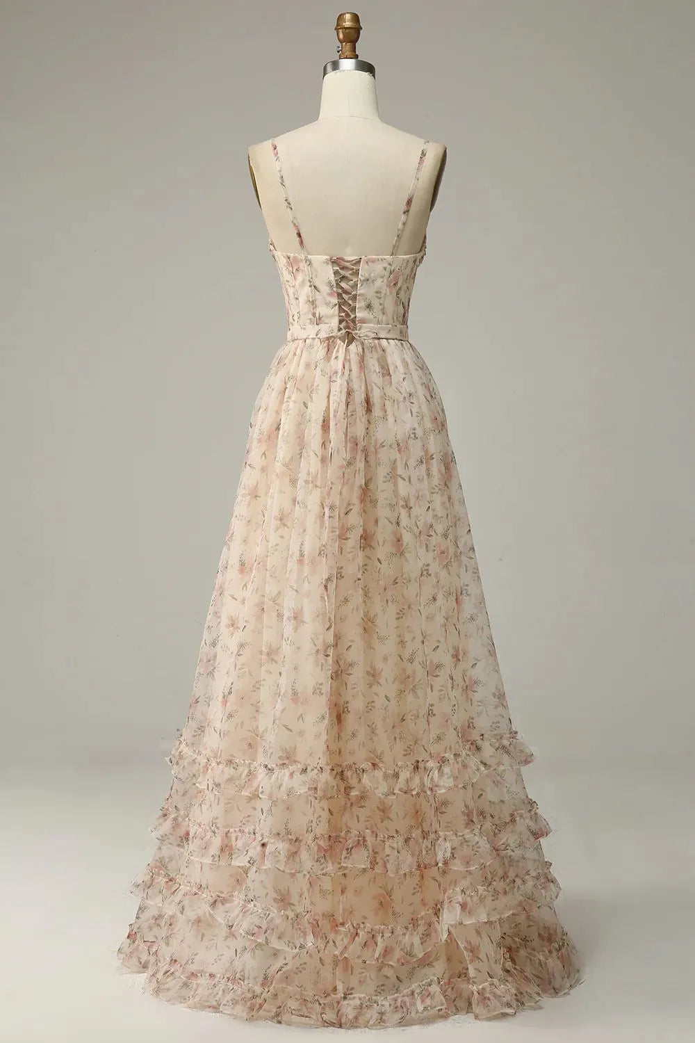 Back view of apricot A-line prom dress, showing flowing skirt and print.