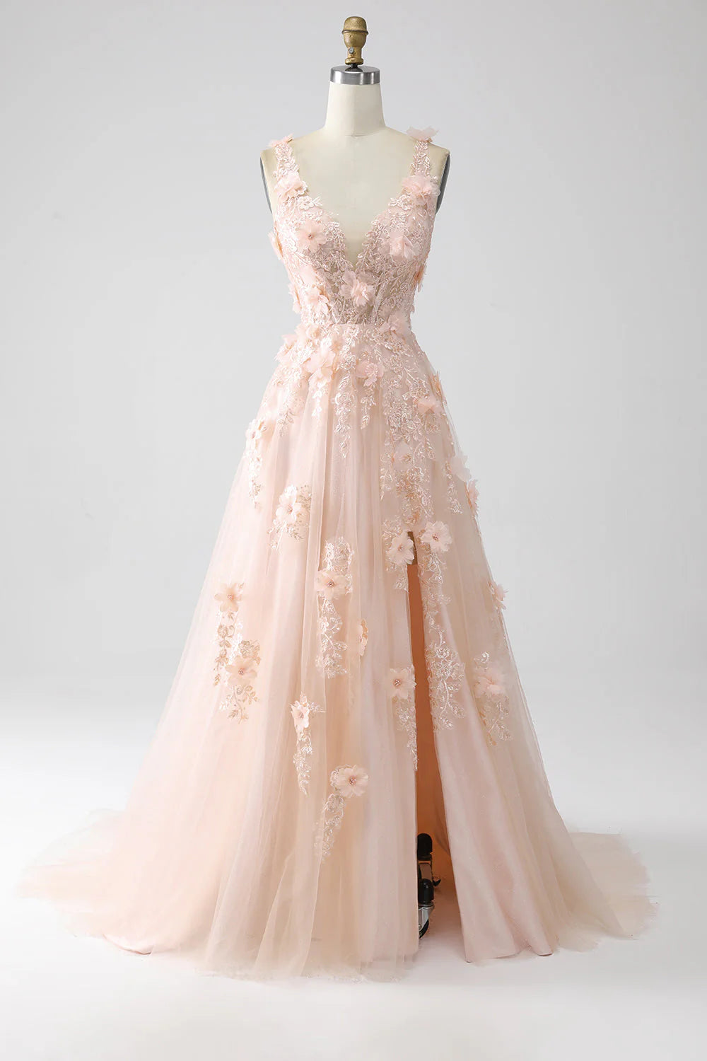 Blush pink A-line prom dress with spaghetti straps and floral appliques, front view.