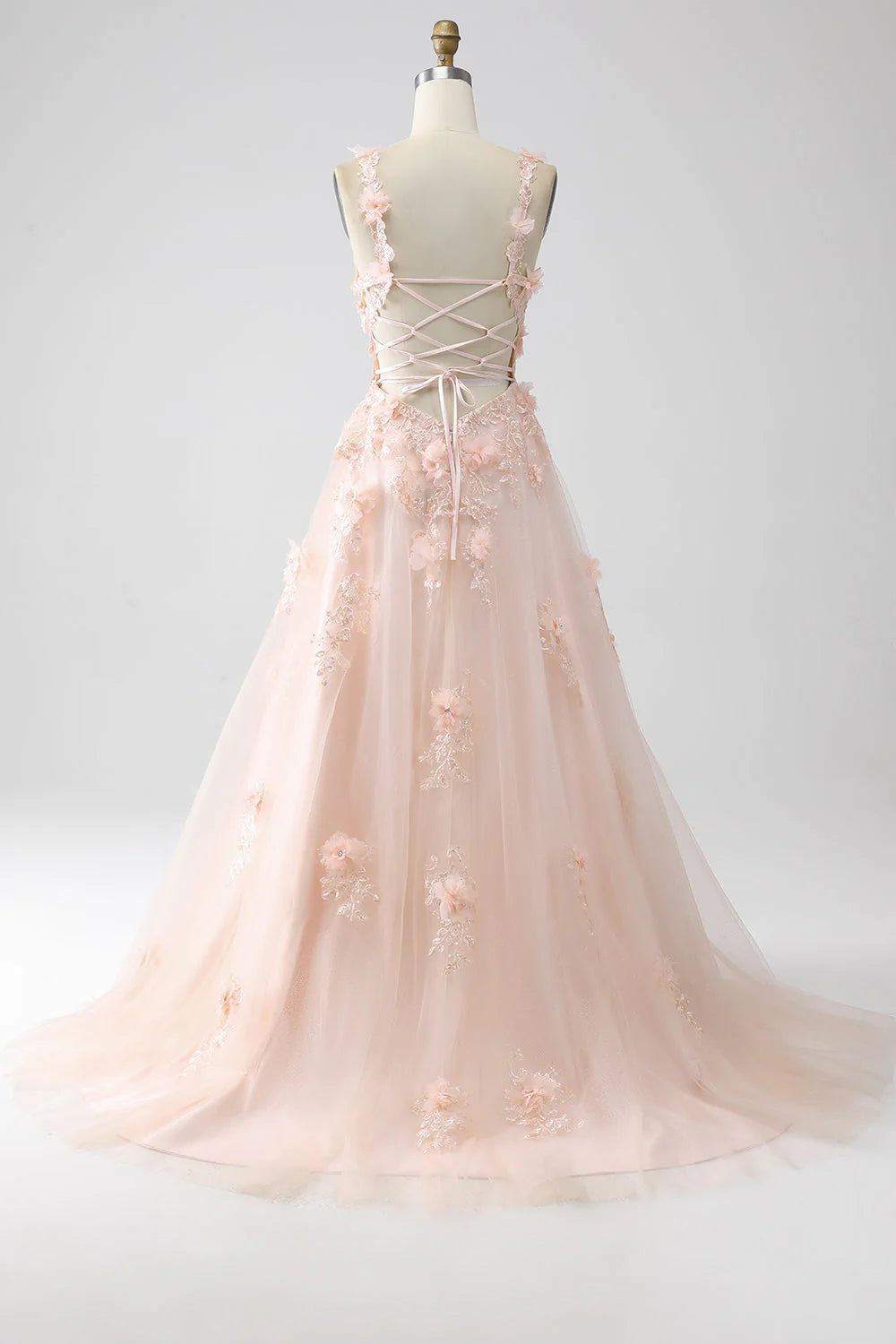 Back view of the blush pink A-line prom dress, showing delicate appliques.