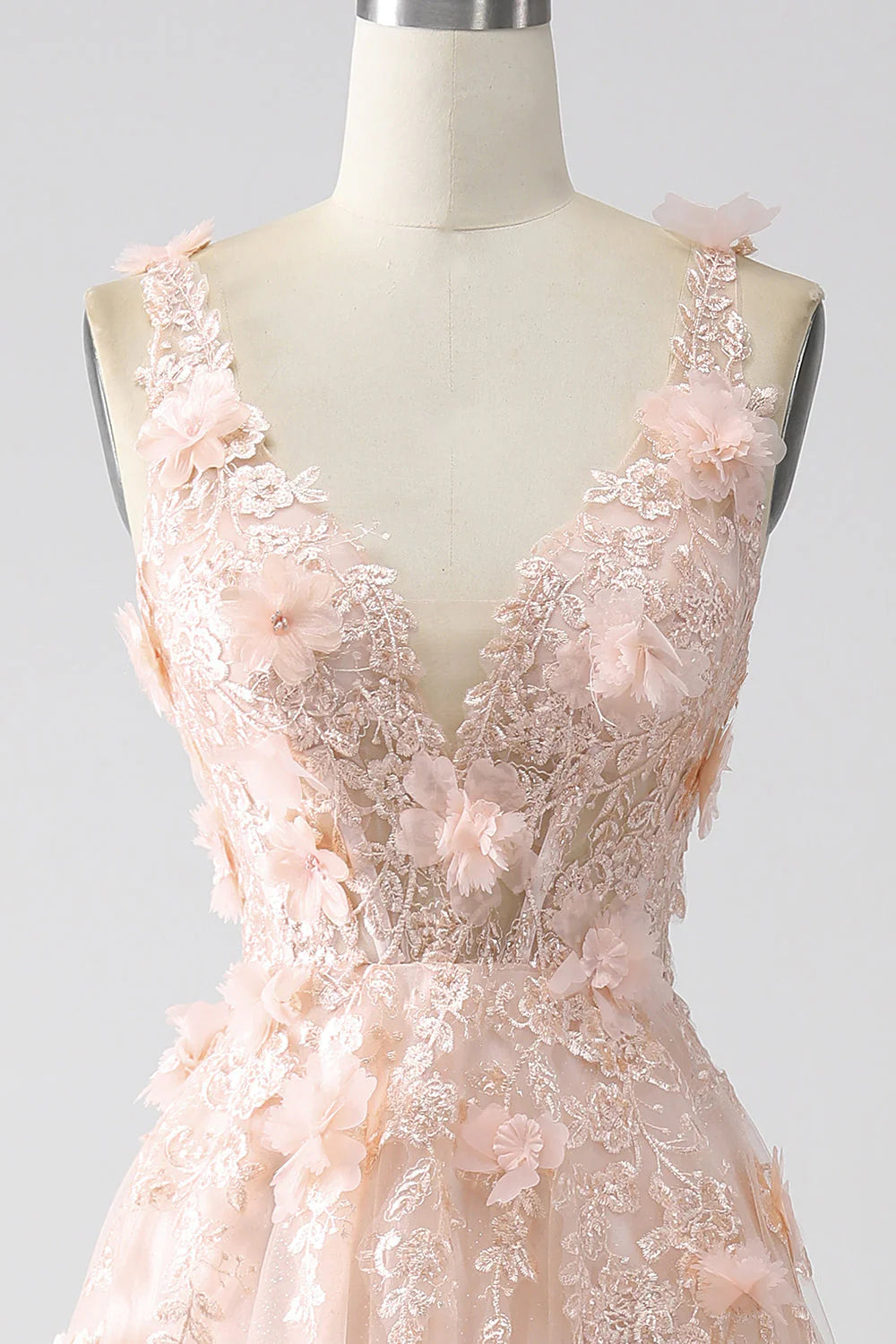 Close-up of the appliques on the bodice of the blush pink prom dress.