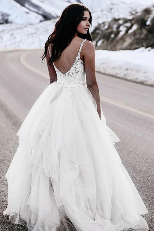 Close-up of the intricate lace and spaghetti straps on the bridal gown.