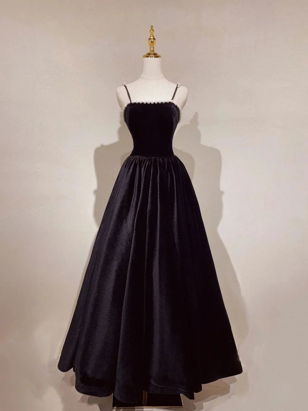 Elegant navy blue A-line prom dress with spaghetti straps.