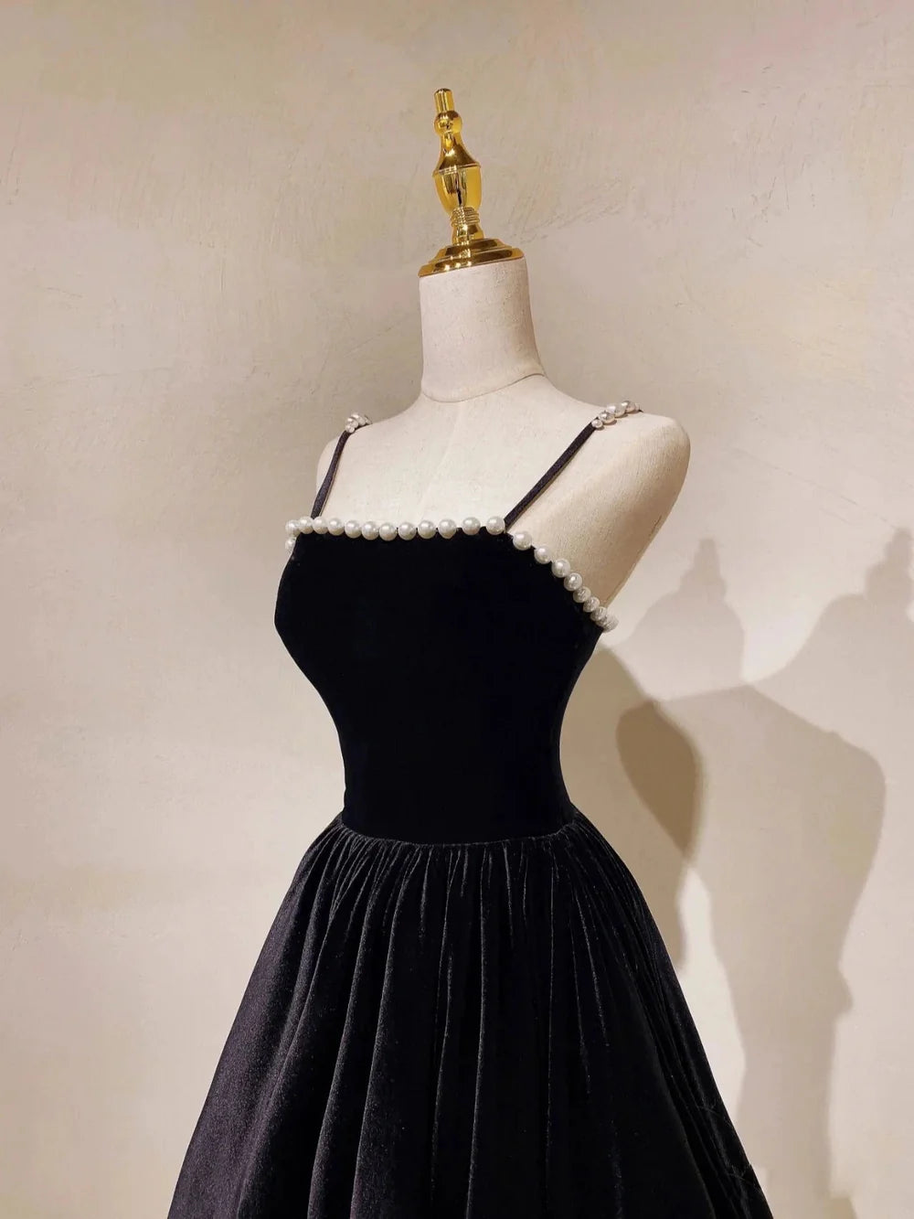 Side view of a flowing navy blue A-line gown.