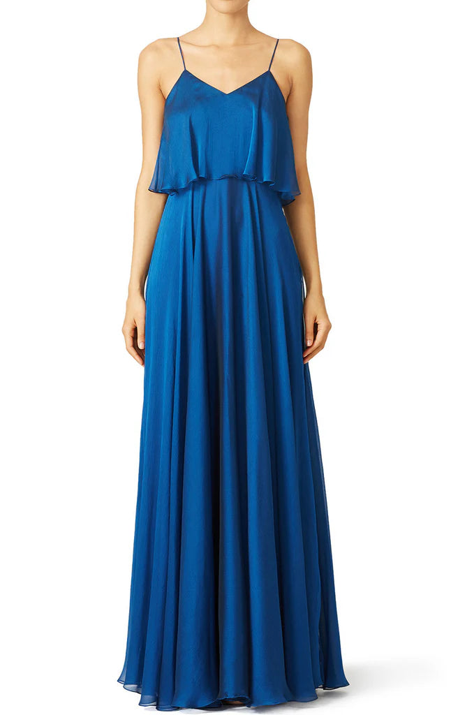 A woman wearing an elegant A-line spaghetti strap chiffon long bridesmaid dress.