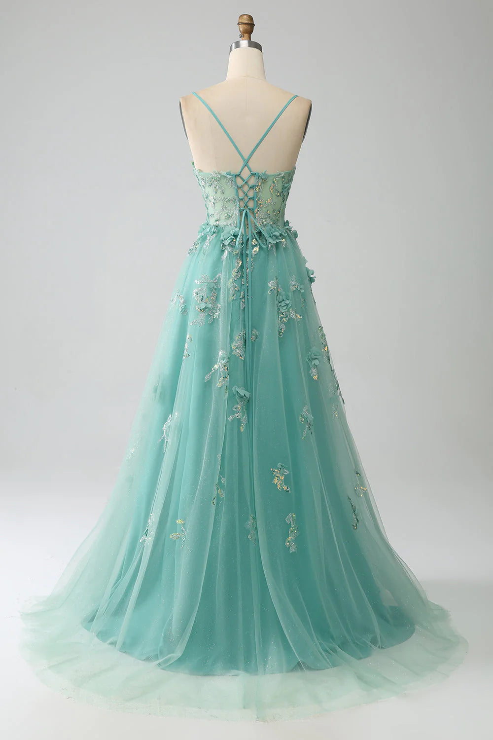 Back view of a green A-line prom dress with corset detailing.