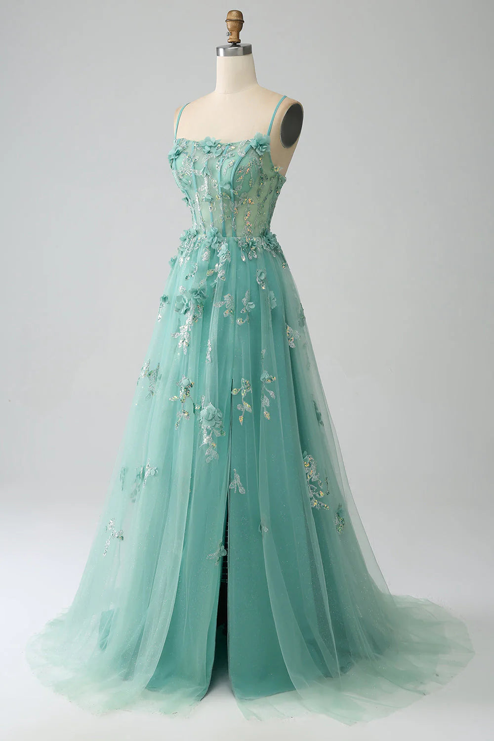 Close-up of appliques on the corset bodice of a green prom dress.