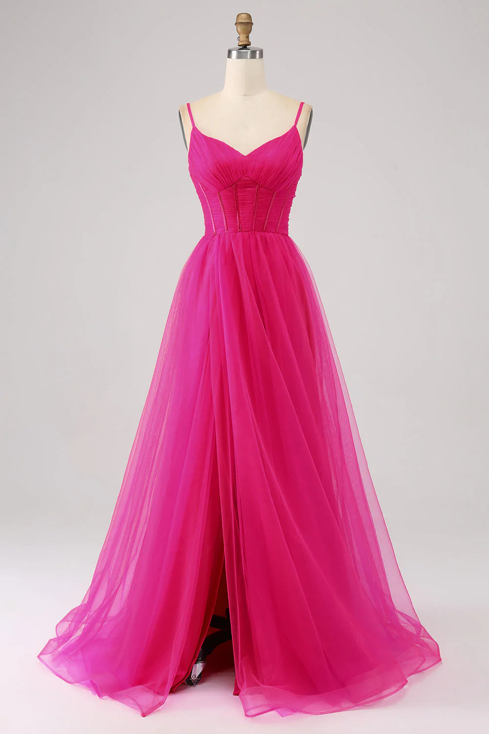 Fuchsia A-Line spaghetti strap prom dress with corset bodice and high slit.