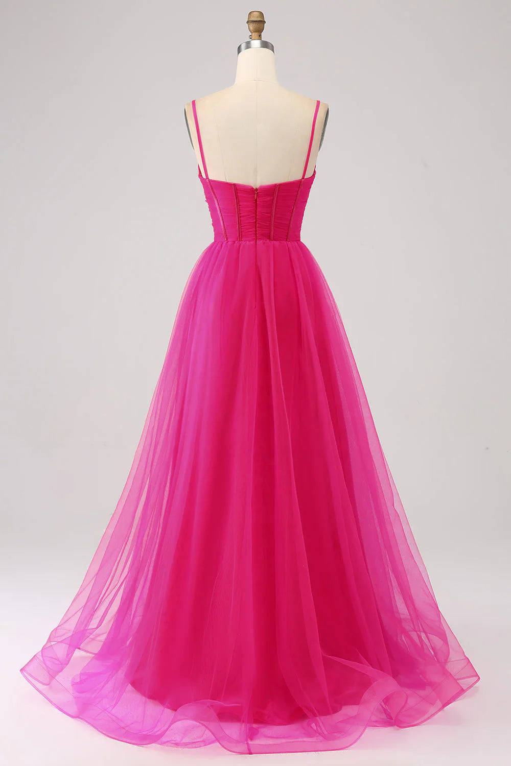 Side view of fuchsia A-Line prom dress showing high slit detail.