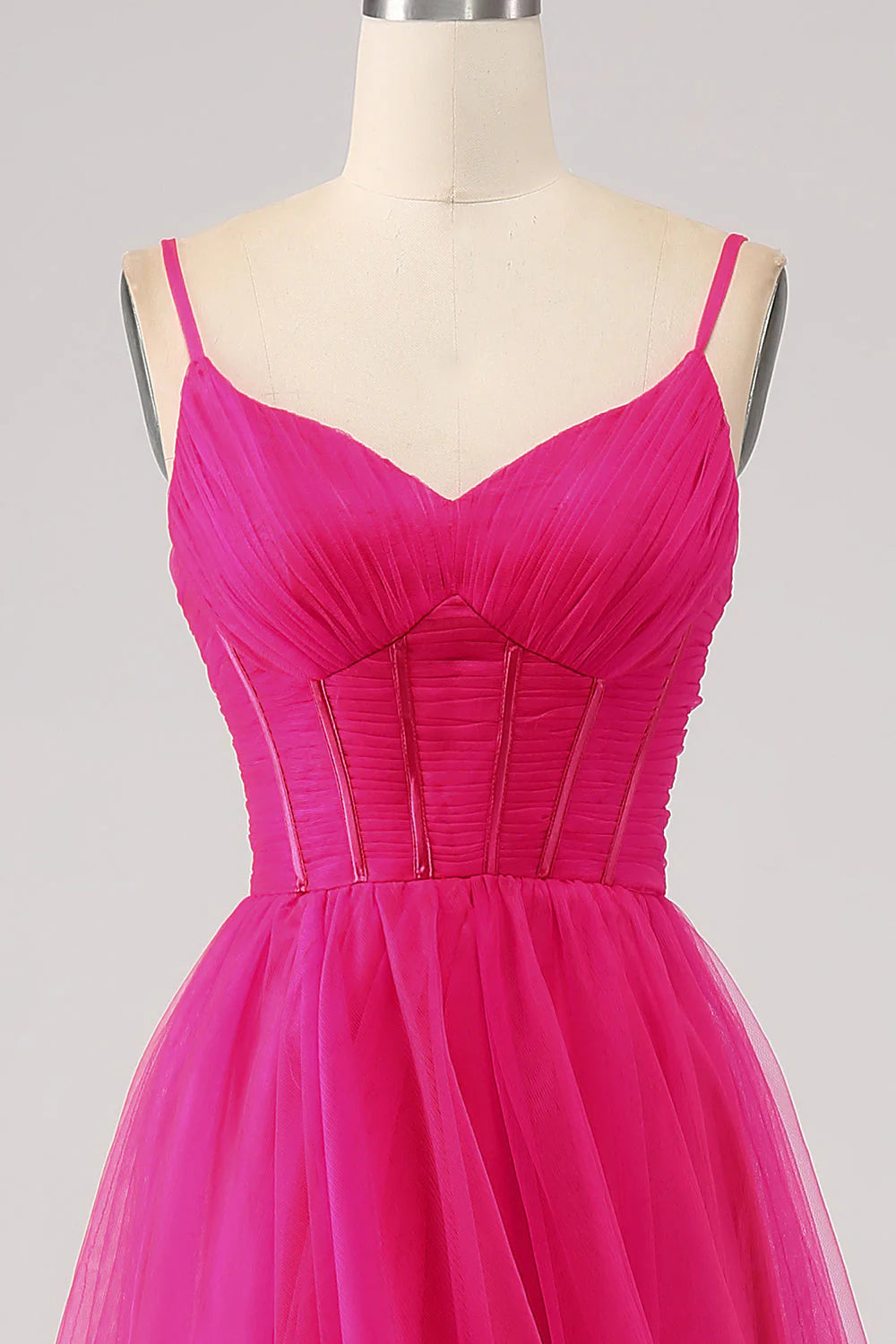 Model wearing fuchsia A-Line long prom dress with spaghetti straps.