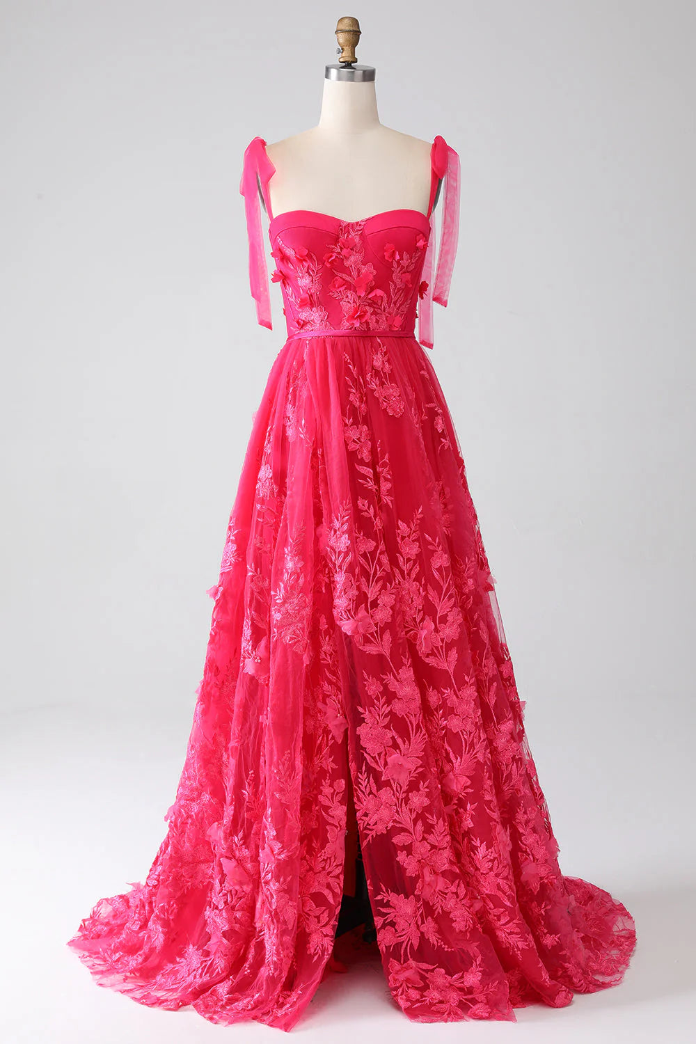 Fuchsia A-line prom dress with spaghetti straps and a high slit.
