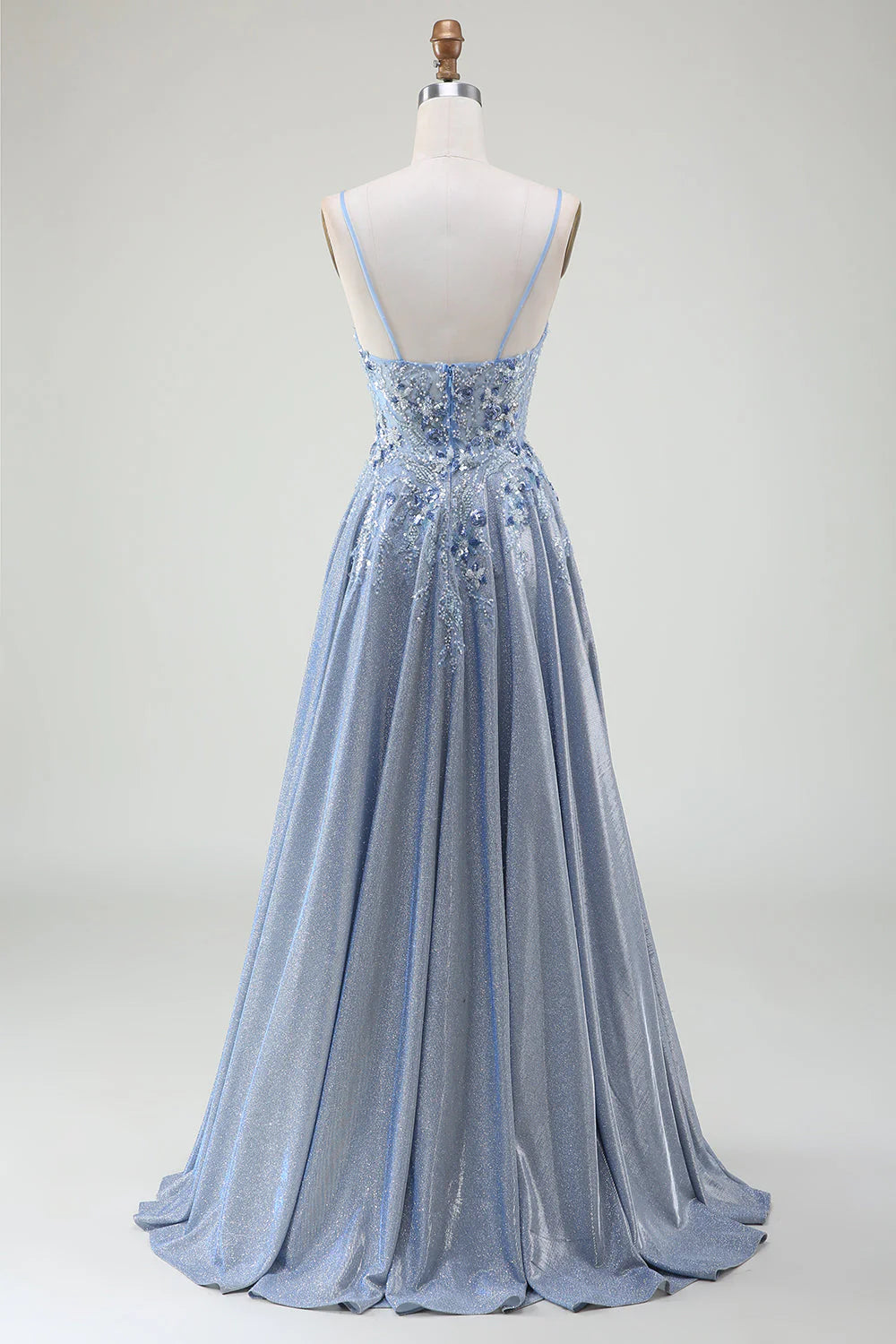 Back view of a woman in a shimmering grey-blue A-line formal dress.