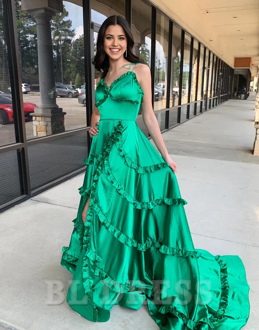 Green satin formal gown with a high slit, showing the flowing A-line skirt.