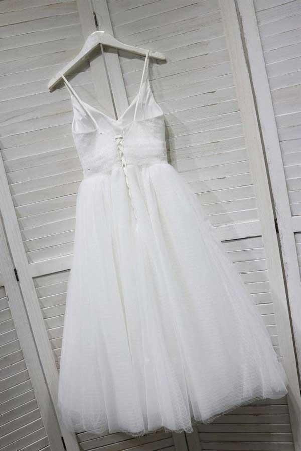 Back view of the flowing A-line tulle dress with delicate spaghetti straps.