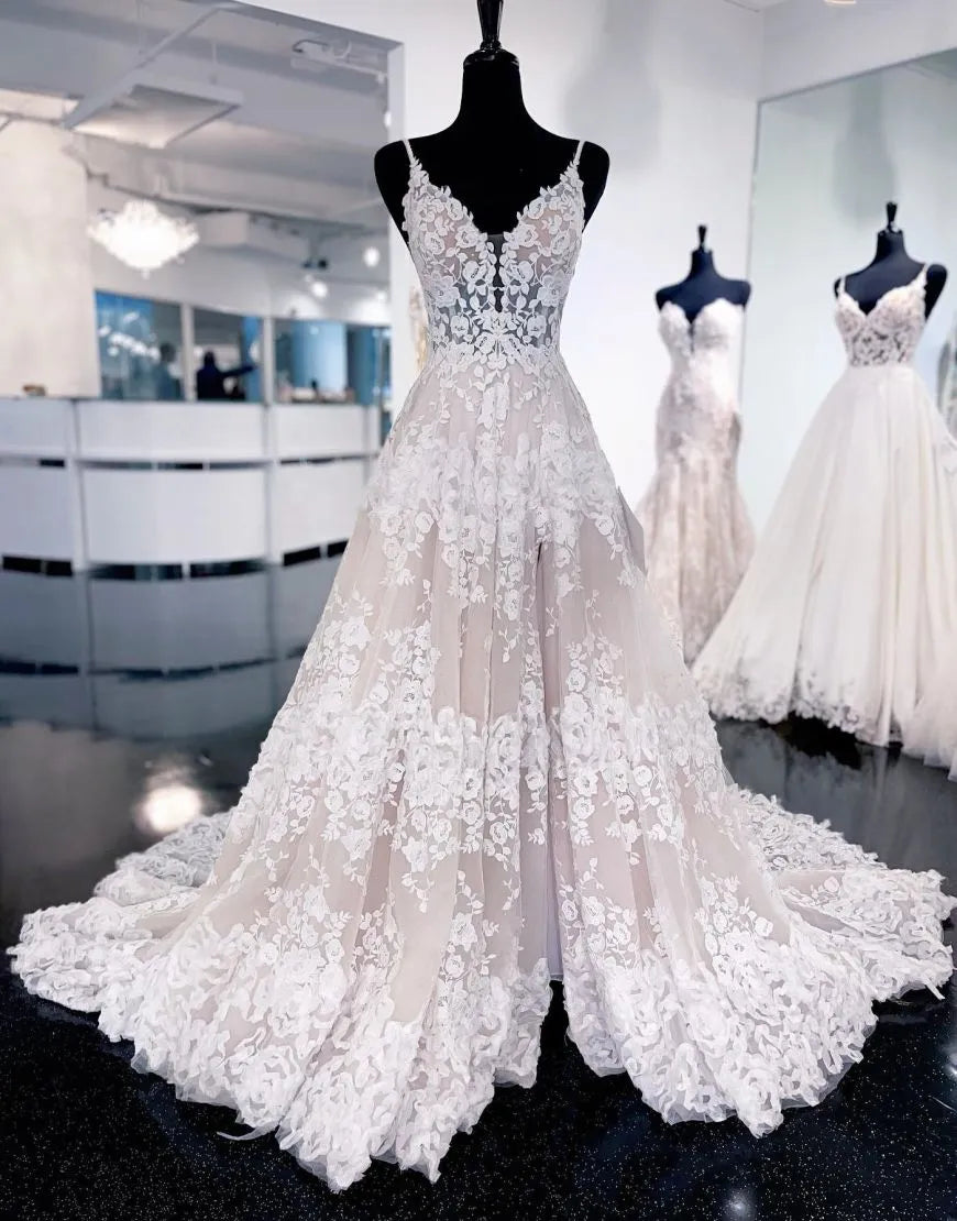 Elegant A-Line wedding dress with spaghetti straps, appliques, and a court train, viewed from the front.