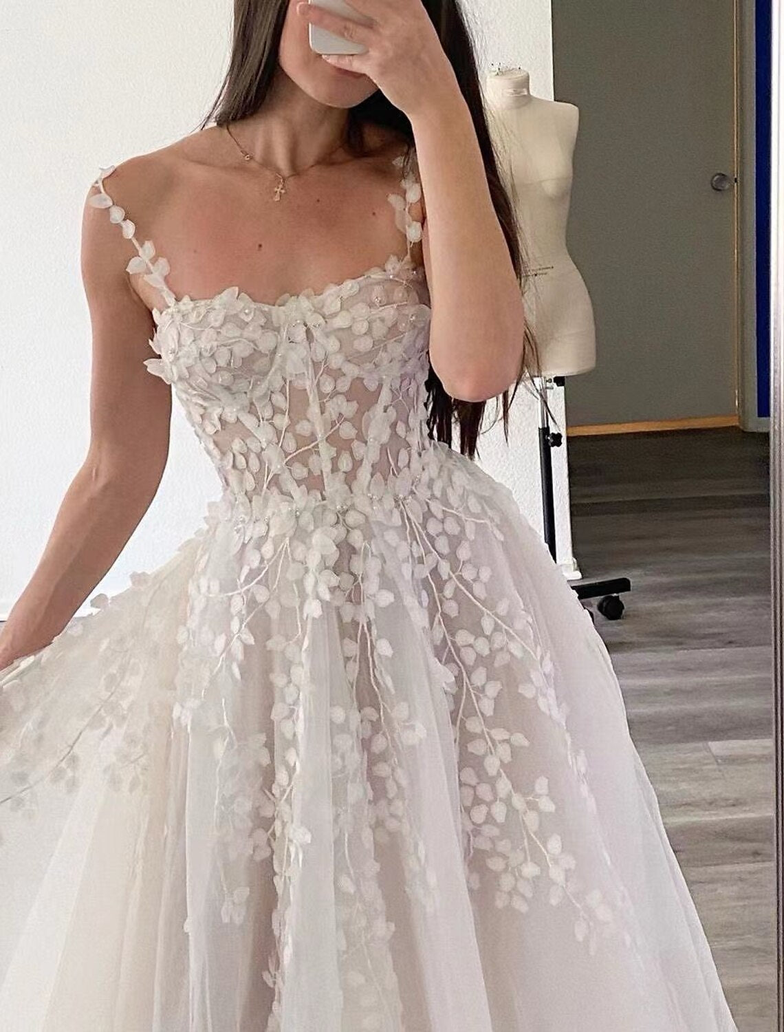 Back view of an A-Line chiffon wedding dress featuring a sweep train and embroidery.