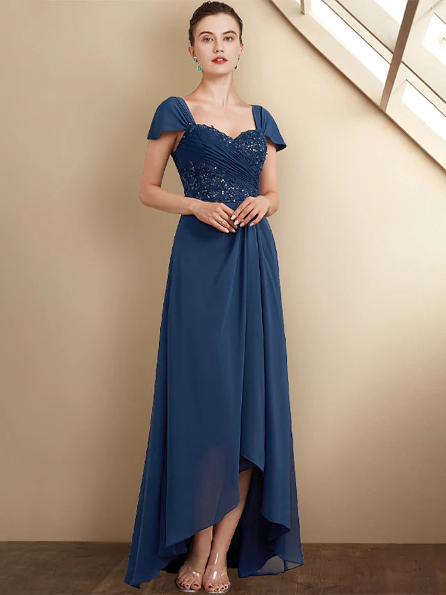 Square neckline and cap sleeves of the formal gown.
