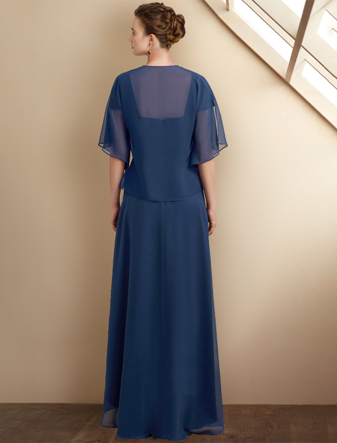 Close-up of the square neckline and cap sleeves with lace and sequin details.