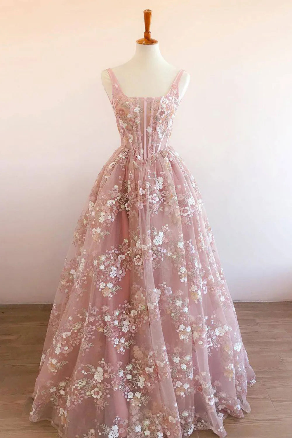 Model wearing an elegant light blue A-line square neck prom dress with intricate embroidery.