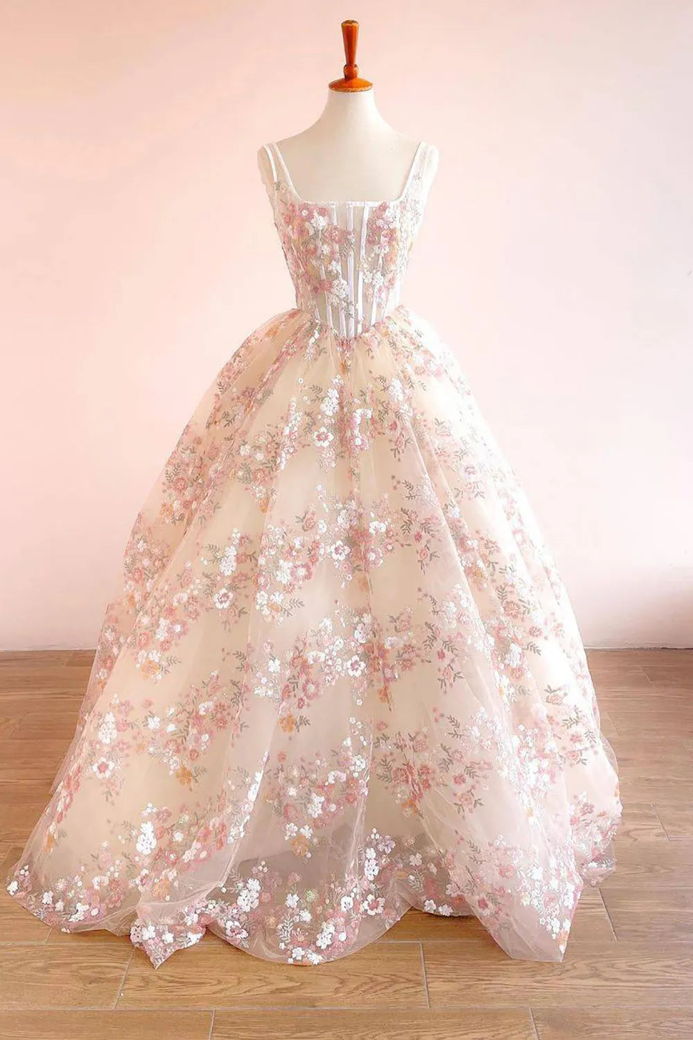 Side profile of the model in the embroidered A-line square neck gown.