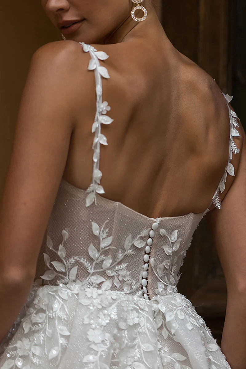 Close-up of lace appliques on the square neck wedding dress.