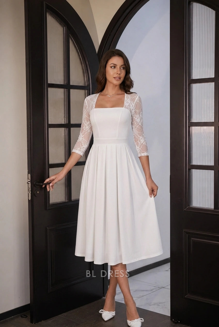 Close-up of square neckline and lace sleeves on white midi dress.