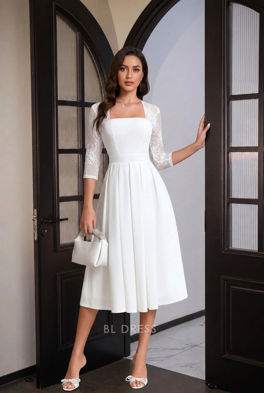 Woman posing elegantly in white A-line midi dress.