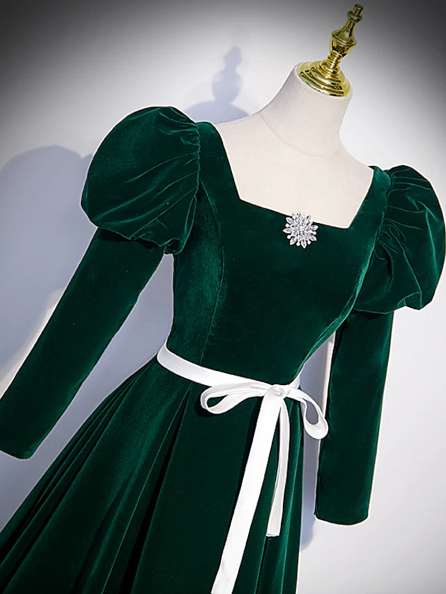 Close-up of the square neckline and long sleeve detail on the gown.