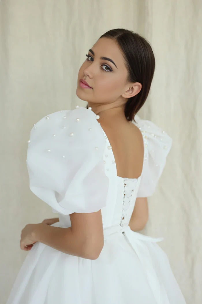 Back view of a short A-line wedding dress with square neckline.