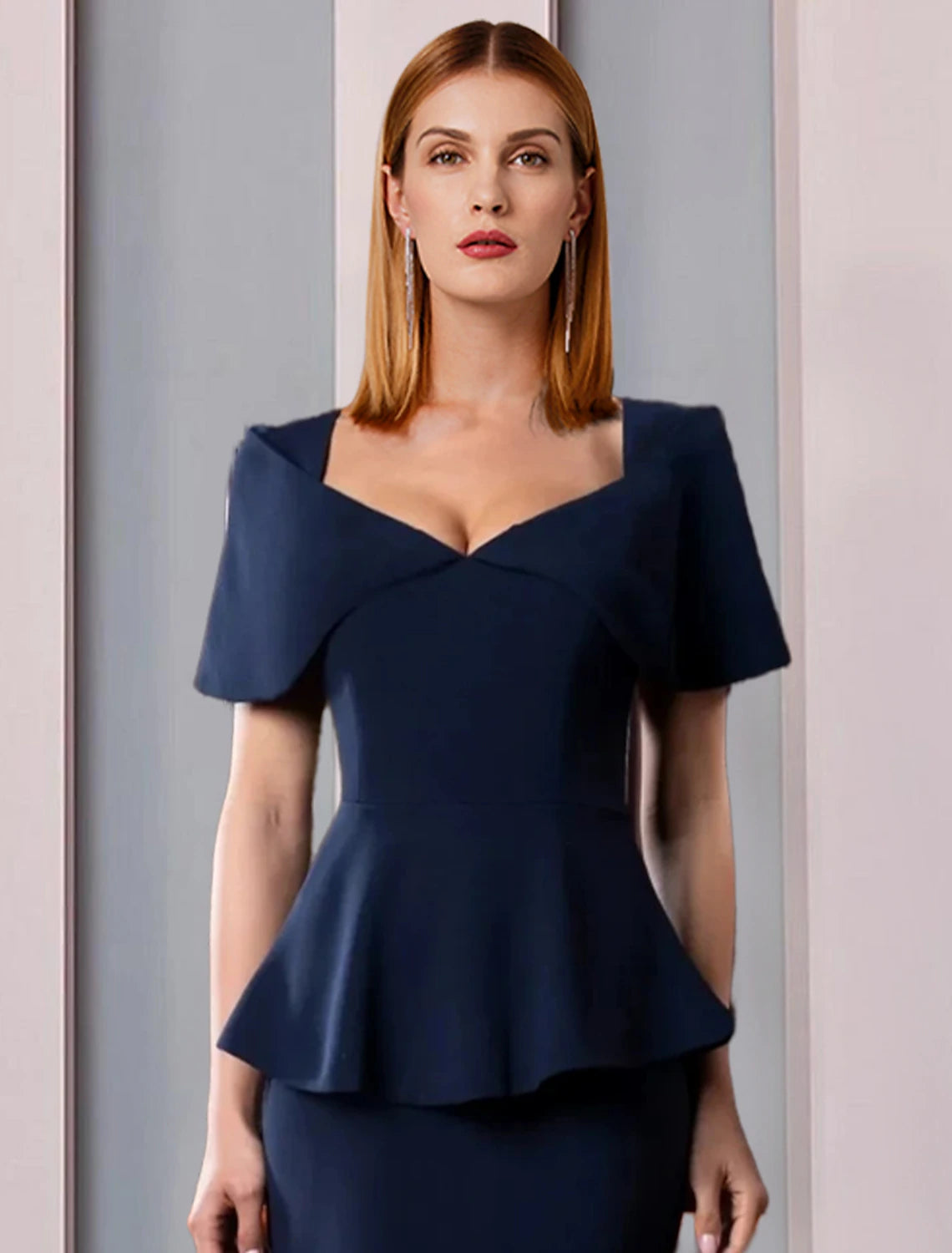 Close-up of the square neckline and ruffled short sleeve on a formal dress.