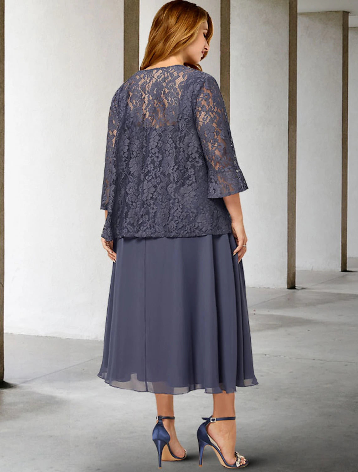 Back view of two-piece tea length formal dress with chiffon fabric.
