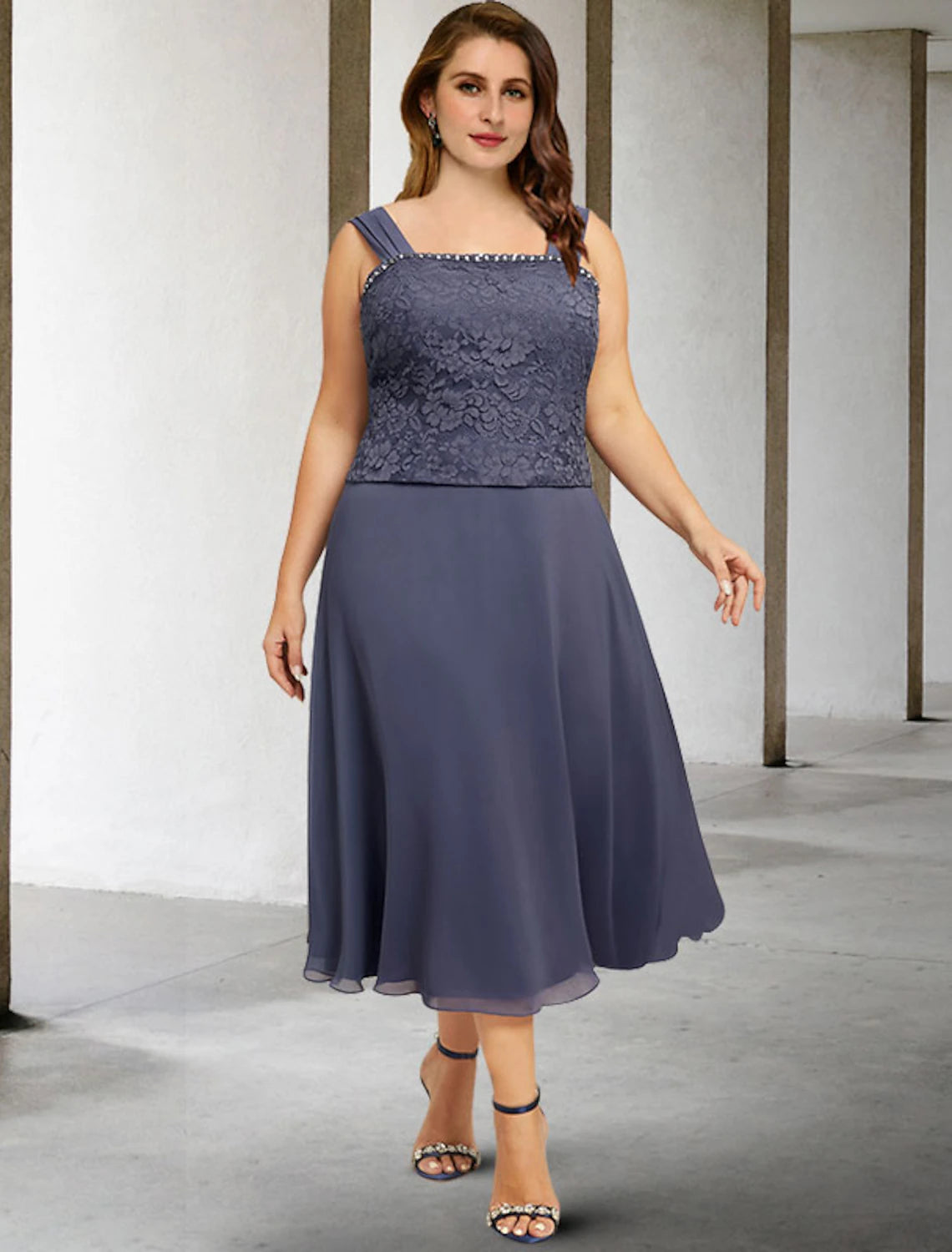 Side profile of sleeveless plus size mother of the bride gown.