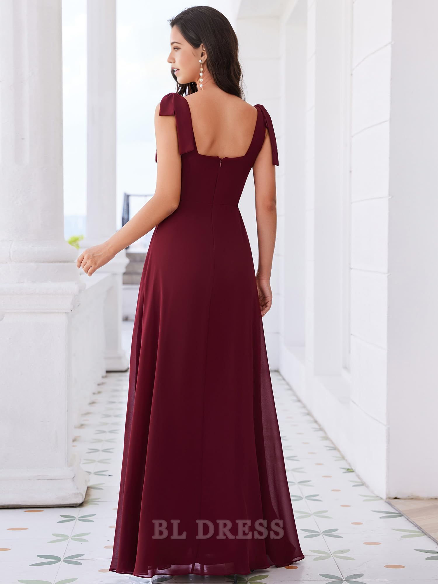Back view of a sleeveless A-line formal dress with square neckline.