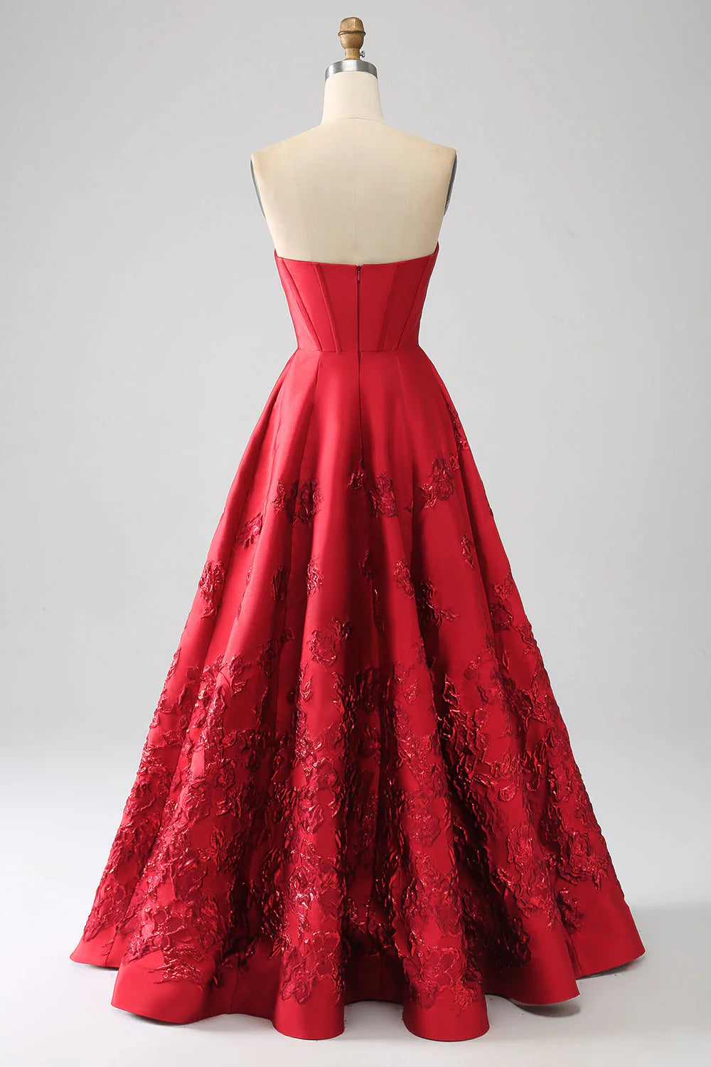 Back view of dark red A-line prom dress with floral details.