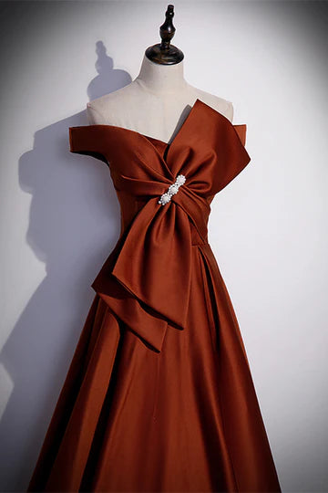 Full length view of A-line formal dress with bow accent.