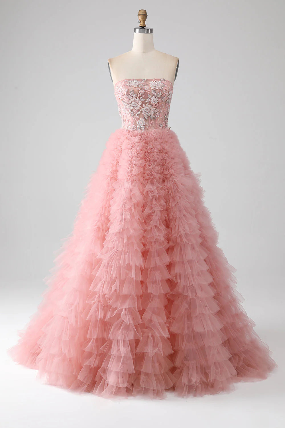 Elegant A-Line strapless beaded tiered blush long prom dress, front view.