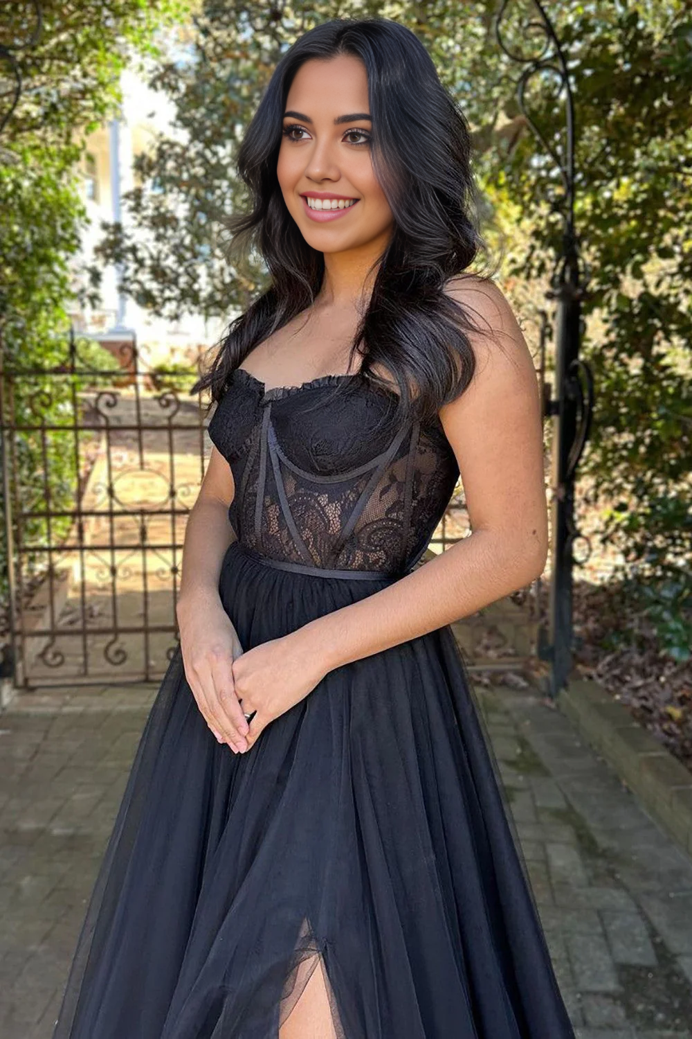 Full view of the black tulle long party dress with a flowing skirt.