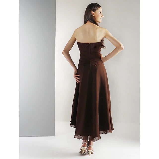 Full view of a graceful tea-length strapless gown in flowing chiffon.