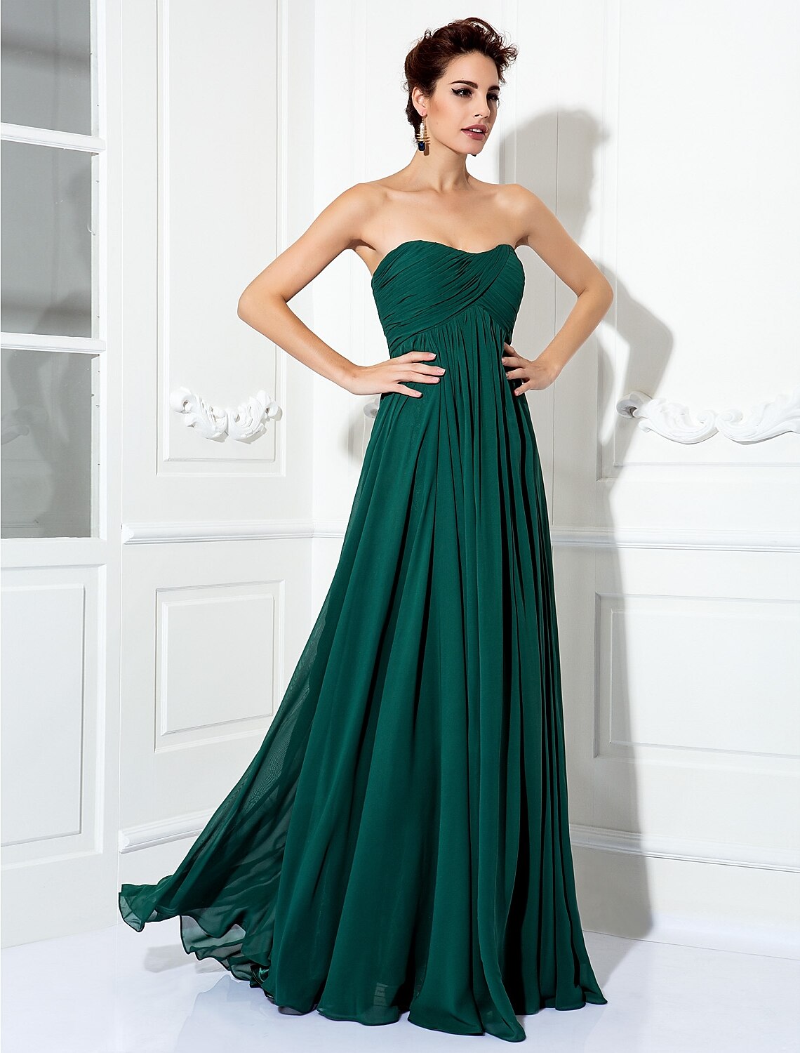Model wearing a strapless A-line dress, showcasing its elegant drape.