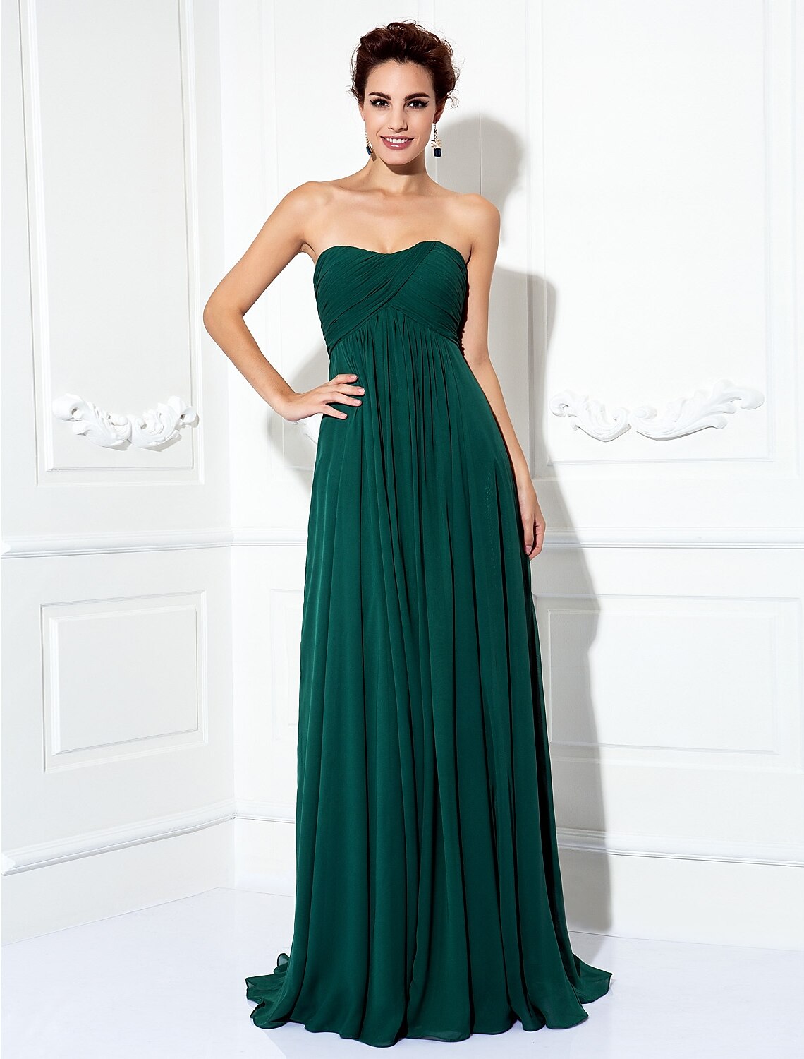 Detailed view of the pleated skirt and train of a formal chiffon gown.
