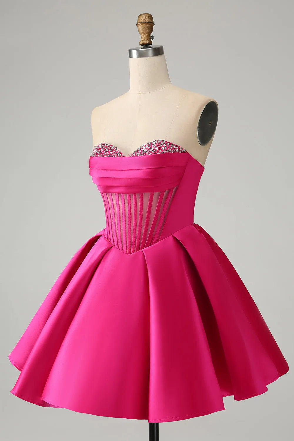 Close-up of beading detail on a fuchsia strapless satin dress.