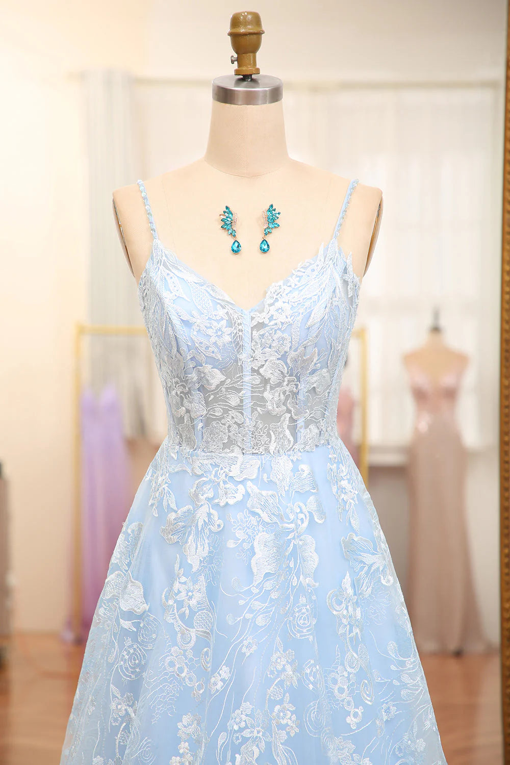 Close-up detail of the delicate appliques on the sky blue corset prom dress.