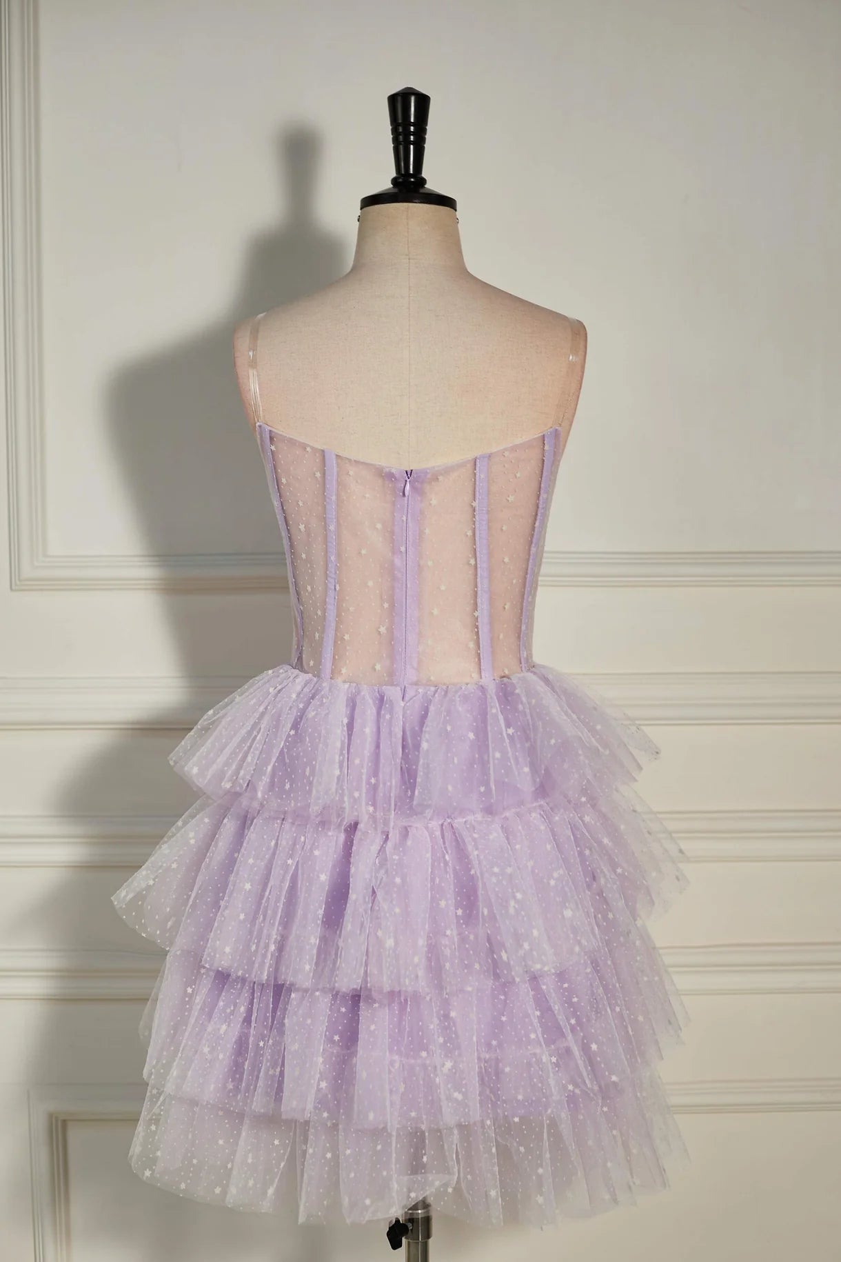 Model posing in a multi-layered dot tulle strapless homecoming dress.