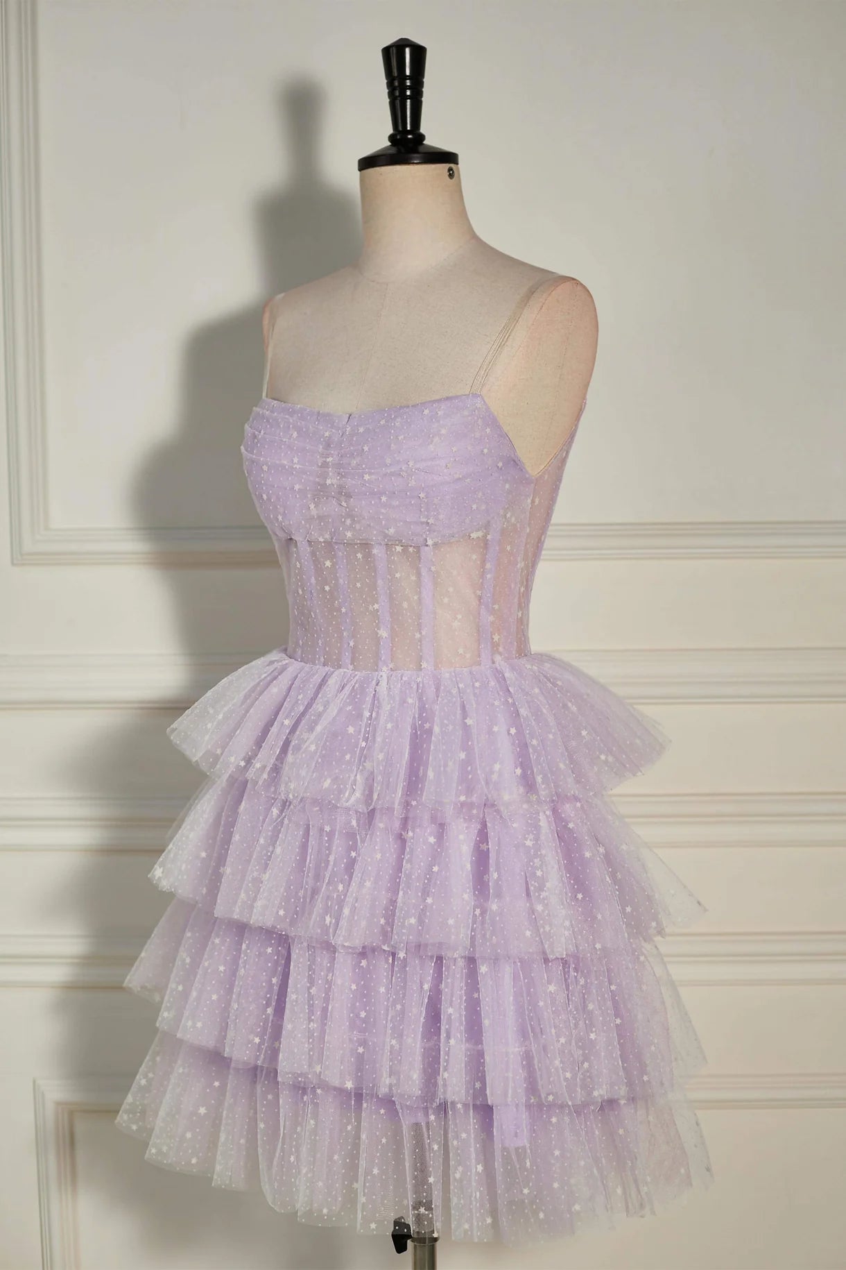 Close-up of the dot tulle fabric and layered skirt of a mini dress.