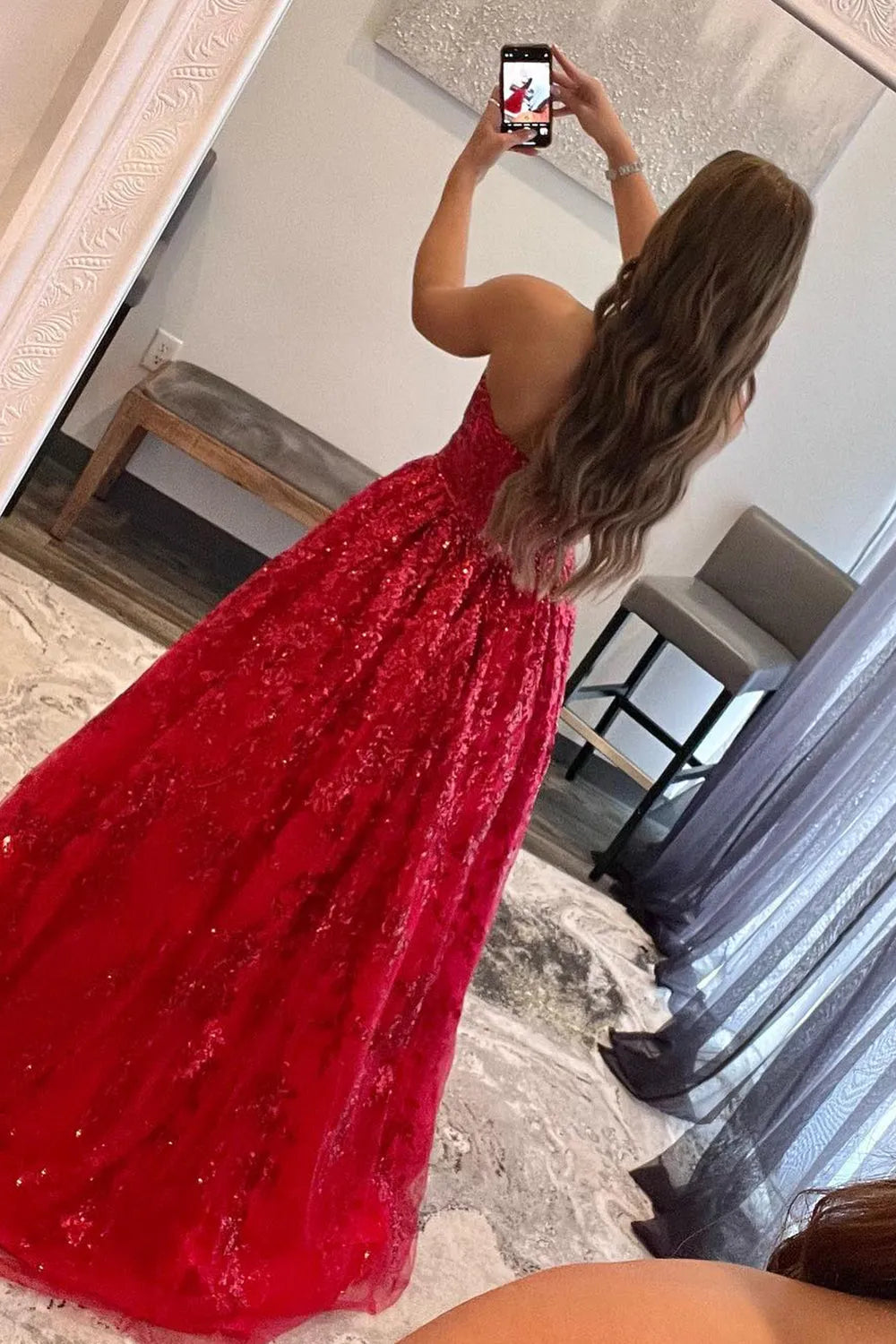 Model gracefully posing in the red A-line long dress.