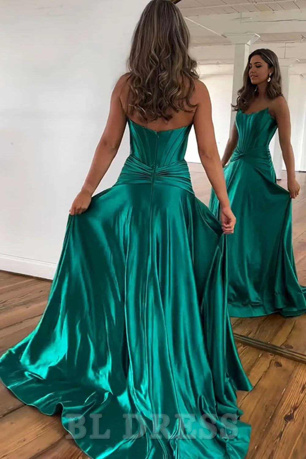 Back view of a green satin formal dress with zipper closure.