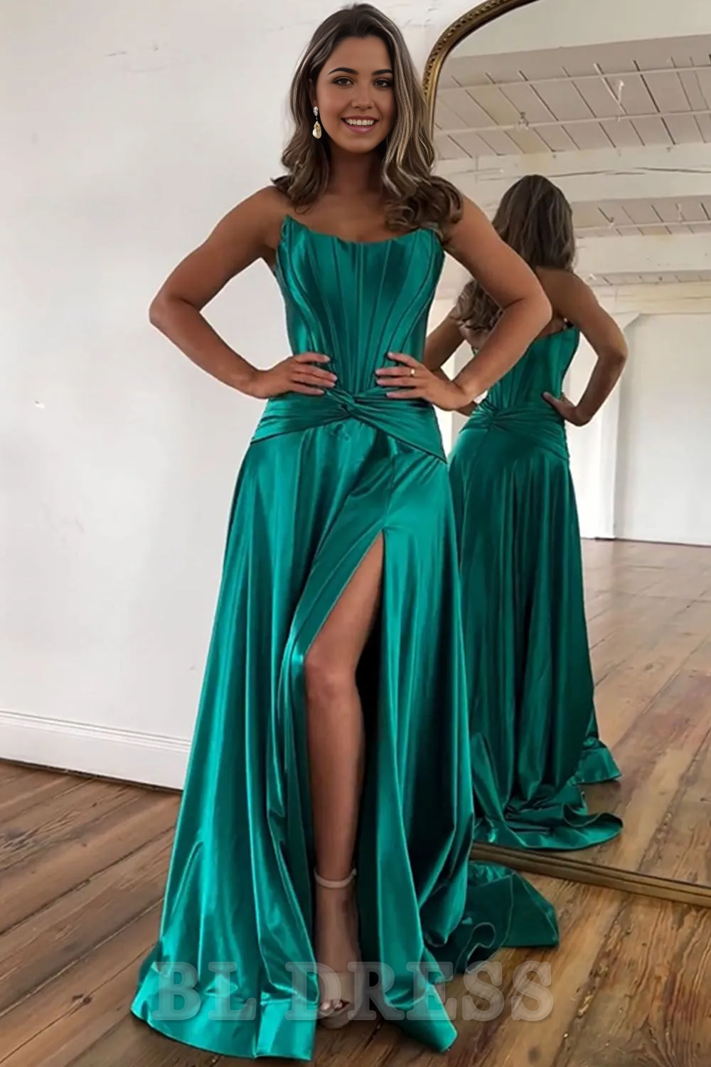 Full length view of a green strapless A-line evening gown.