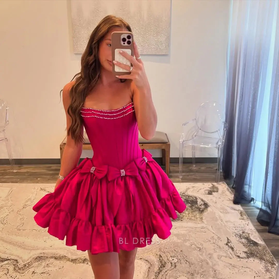 Model wearing a hot pink A-line strapless short satin dress.