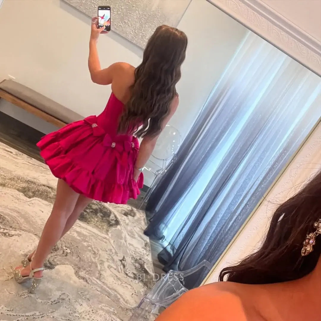 Hot pink A-line strapless satin short dress on a model.