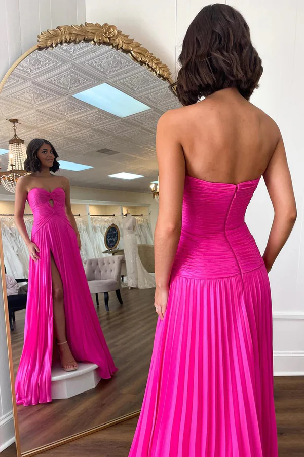 Side view of pleated navy A-line prom gown.